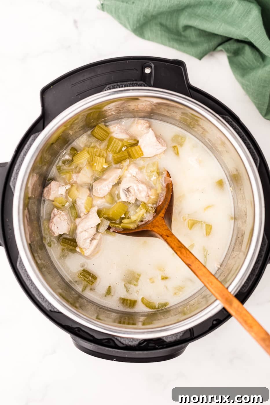 Creamy cooked coconut chicken simmering in the Instant Pot, ready to be served.