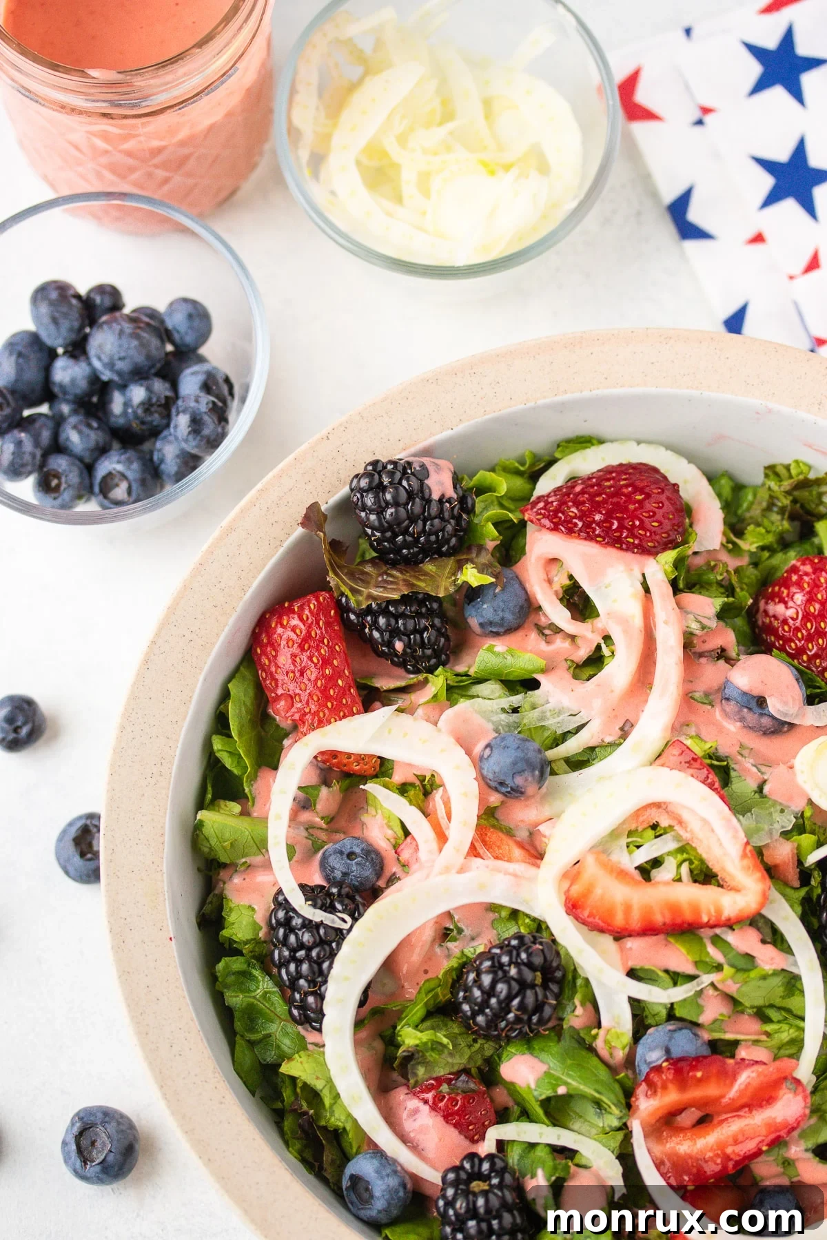 Fresh salad with strawberry dressing and a festive patriotic napkin.