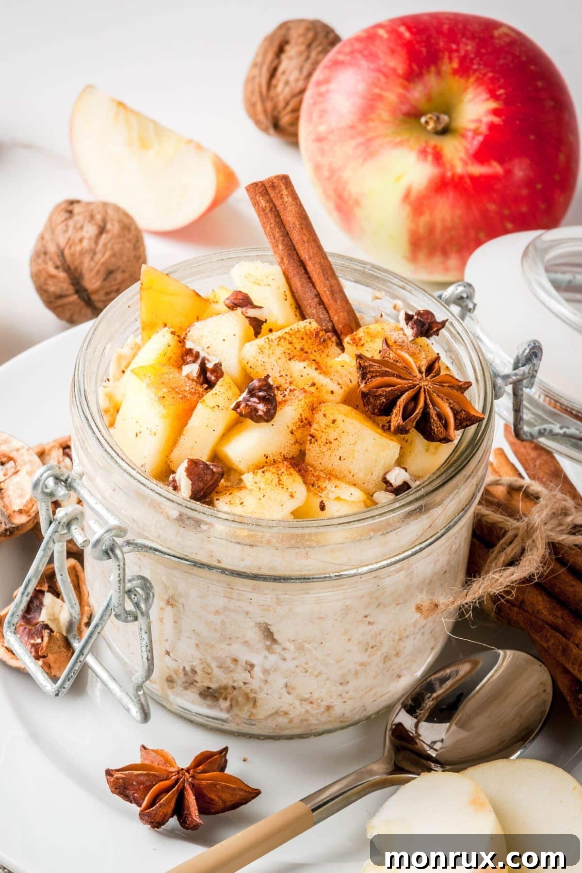 Creamy Instant Pot Steel Cut Oats served in a glass jar, garnished with fresh apple slices and a sprinkle of cinnamon, perfect for a healthy breakfast.
