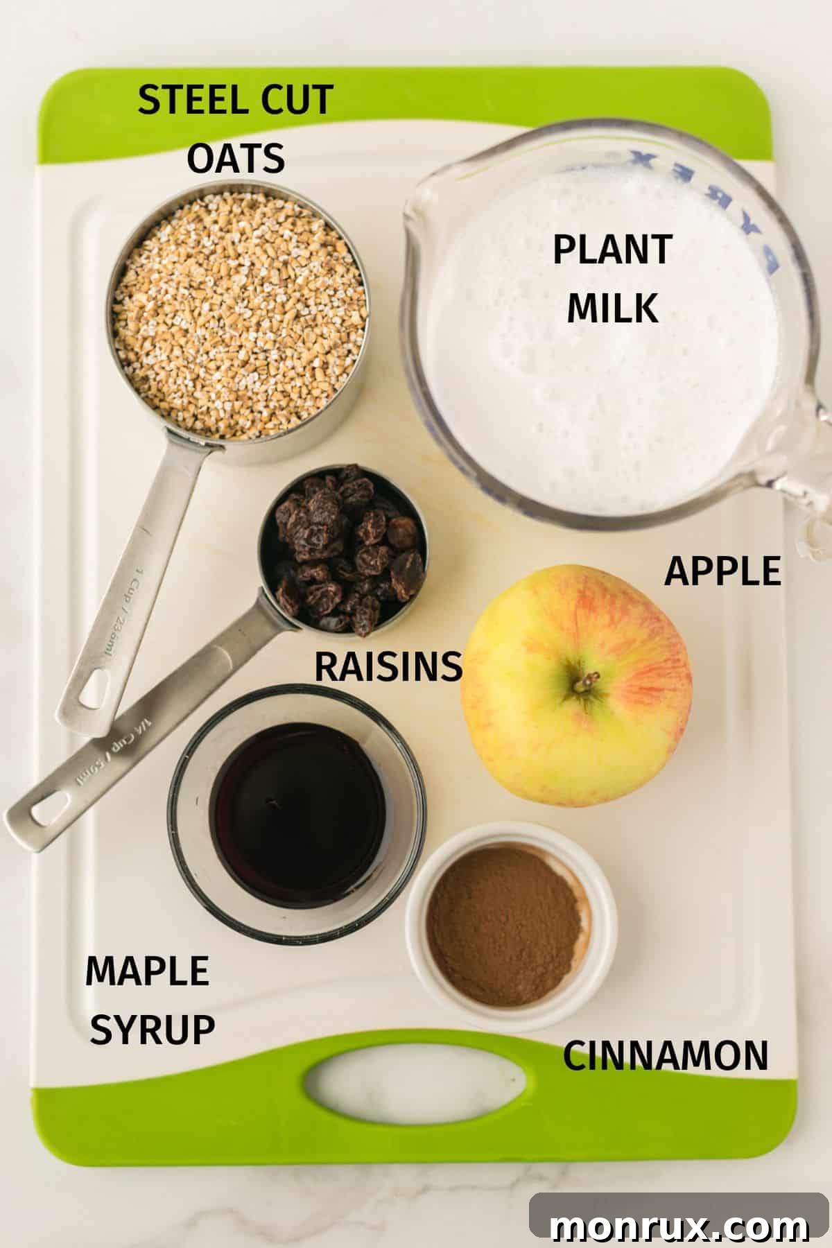 Selection of fresh ingredients for Instant Pot Steel Cut Oats including steel cut oats, plant milk, diced apple, cinnamon, raisins, and maple syrup.