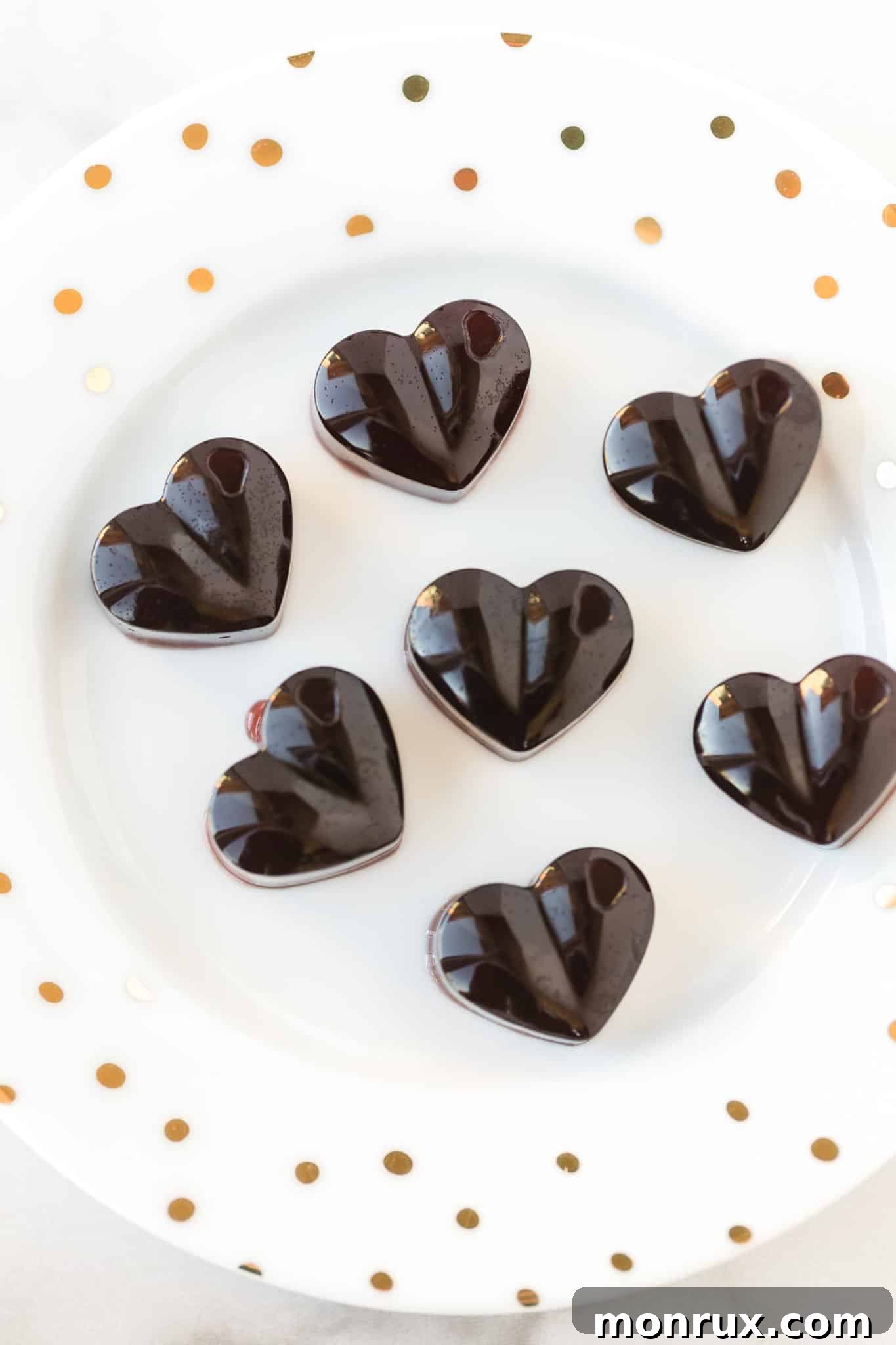 heart shaped homemade cbd gummies on a white plate, symbolizing purity and care.