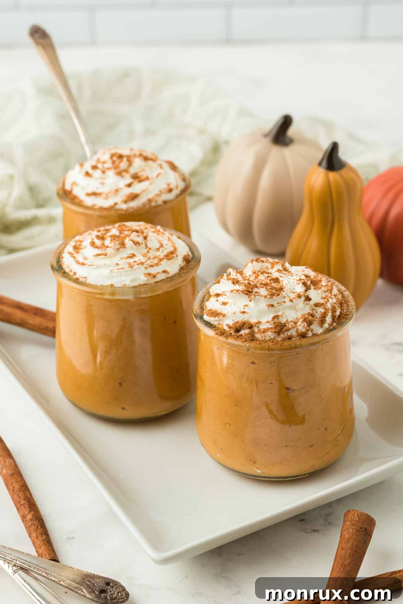 Finished Instant Pot Pumpkin Pudding resting on a rustic wooden table, ready to be served, with a spoon nearby.