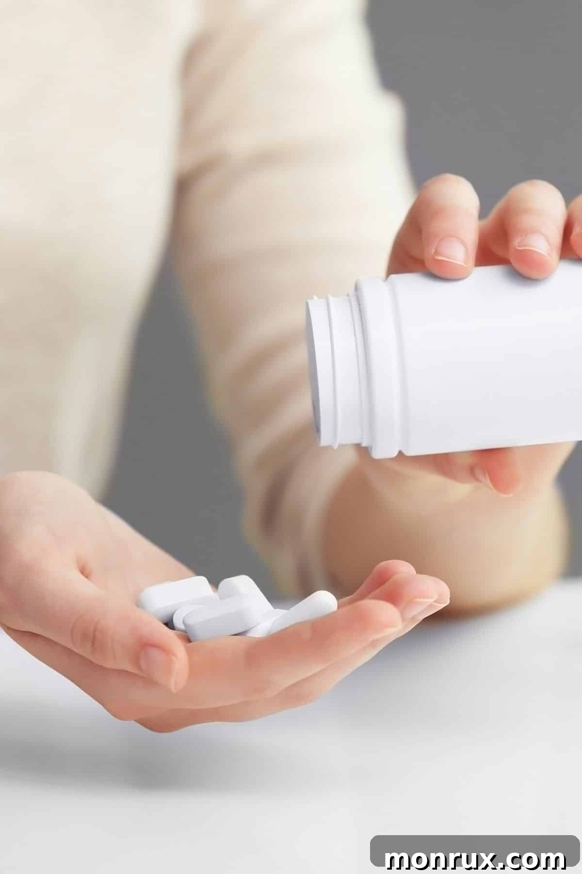 woman pouring vitamins into hand.
