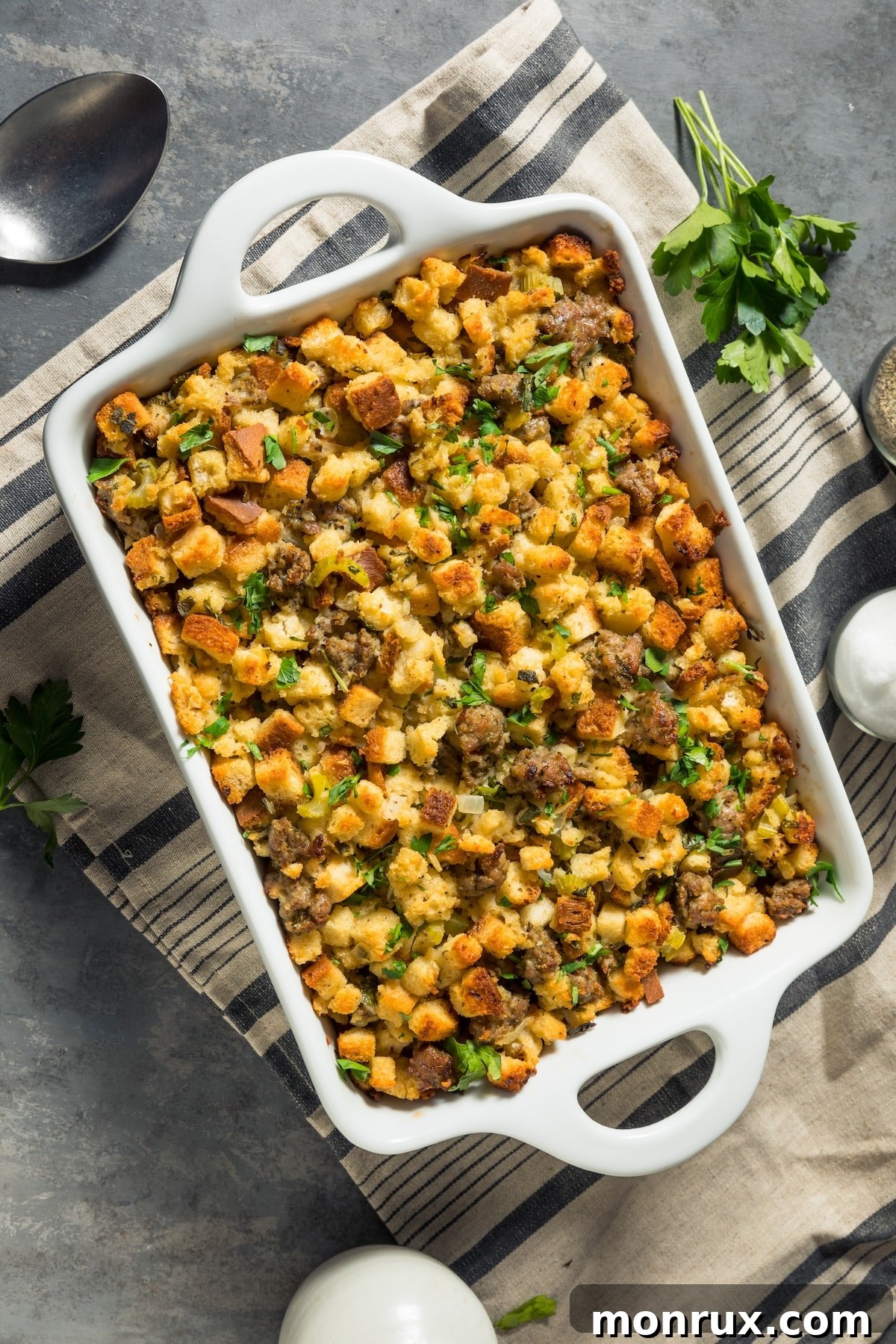 Instant Pot stuffing with savory sausage in a beautiful white serving dish, ready for Thanksgiving.