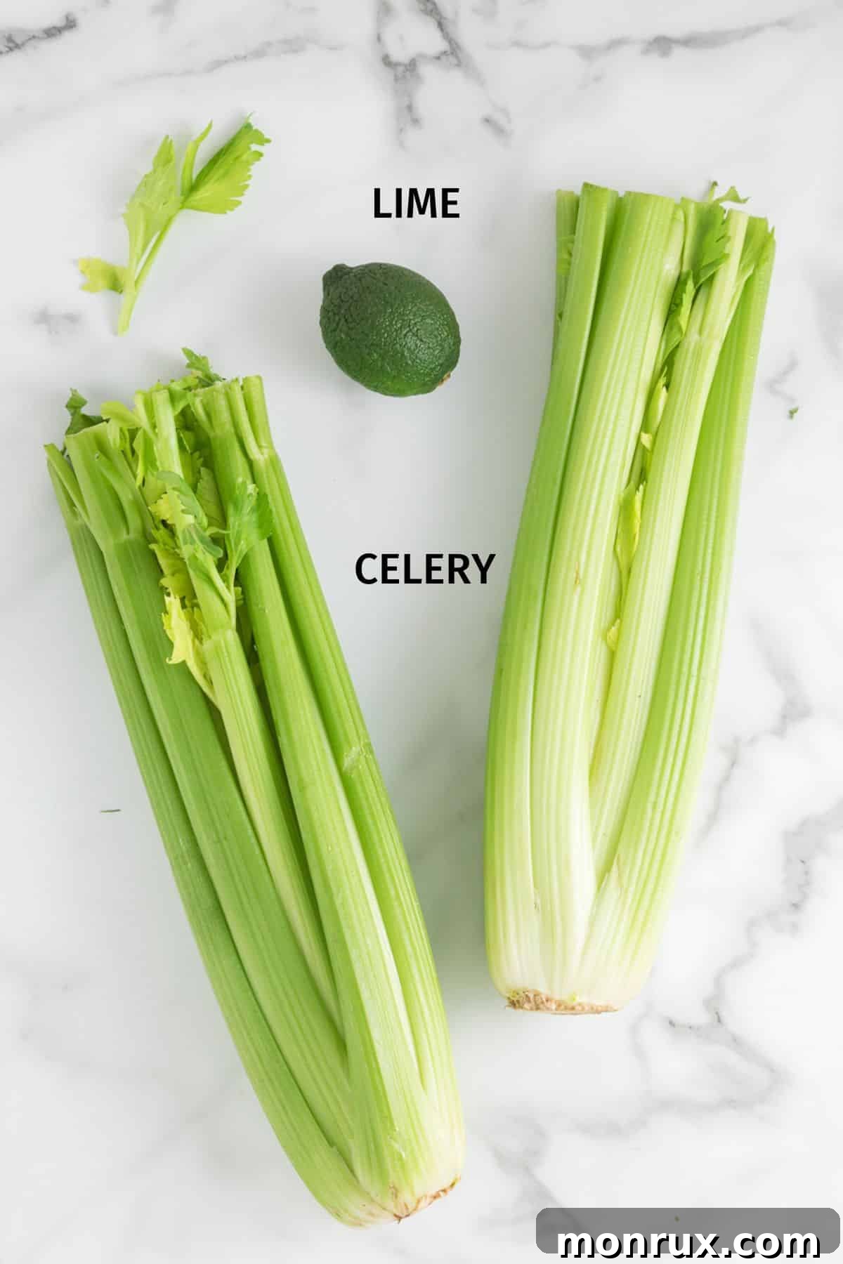 Fresh organic celery stalks and a peeled lime, neatly arranged as ingredients for making celery juice.