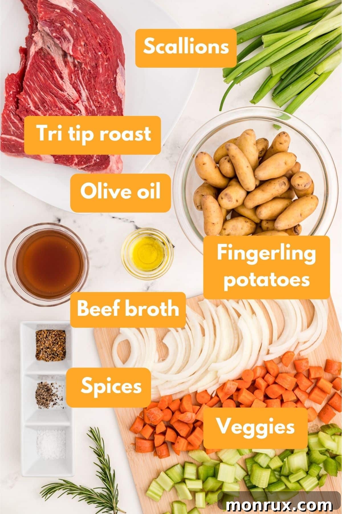 Fresh ingredients laid out for making a slow cooker tri-tip roast, including a beef roast, various root vegetables, and herbs.