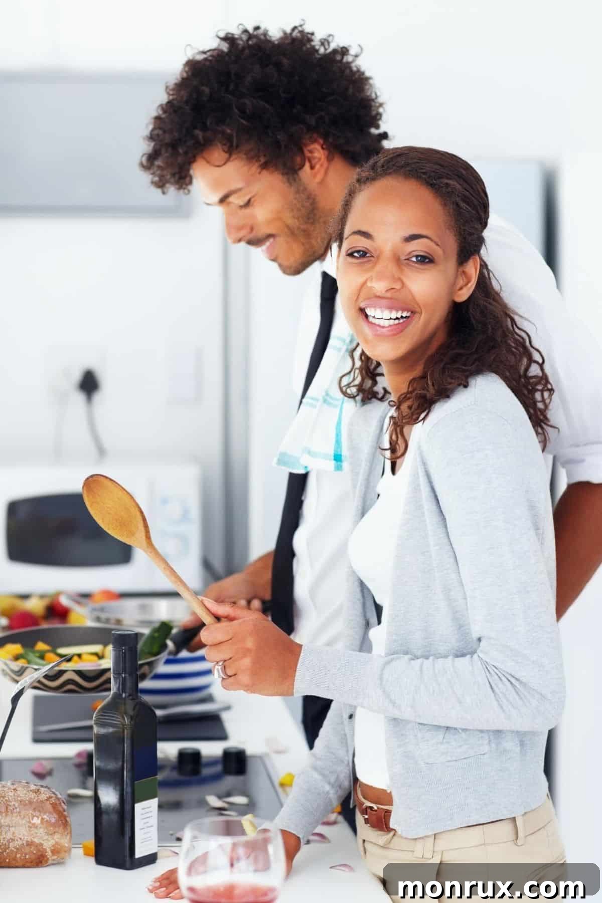 A young couple happily cooking together, symbolizing healthy and joyful eating.