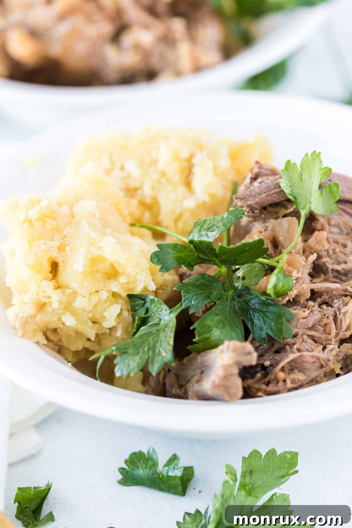A hearty bowl of shredded corned beef with creamy mashed potatoes, ready to be enjoyed.