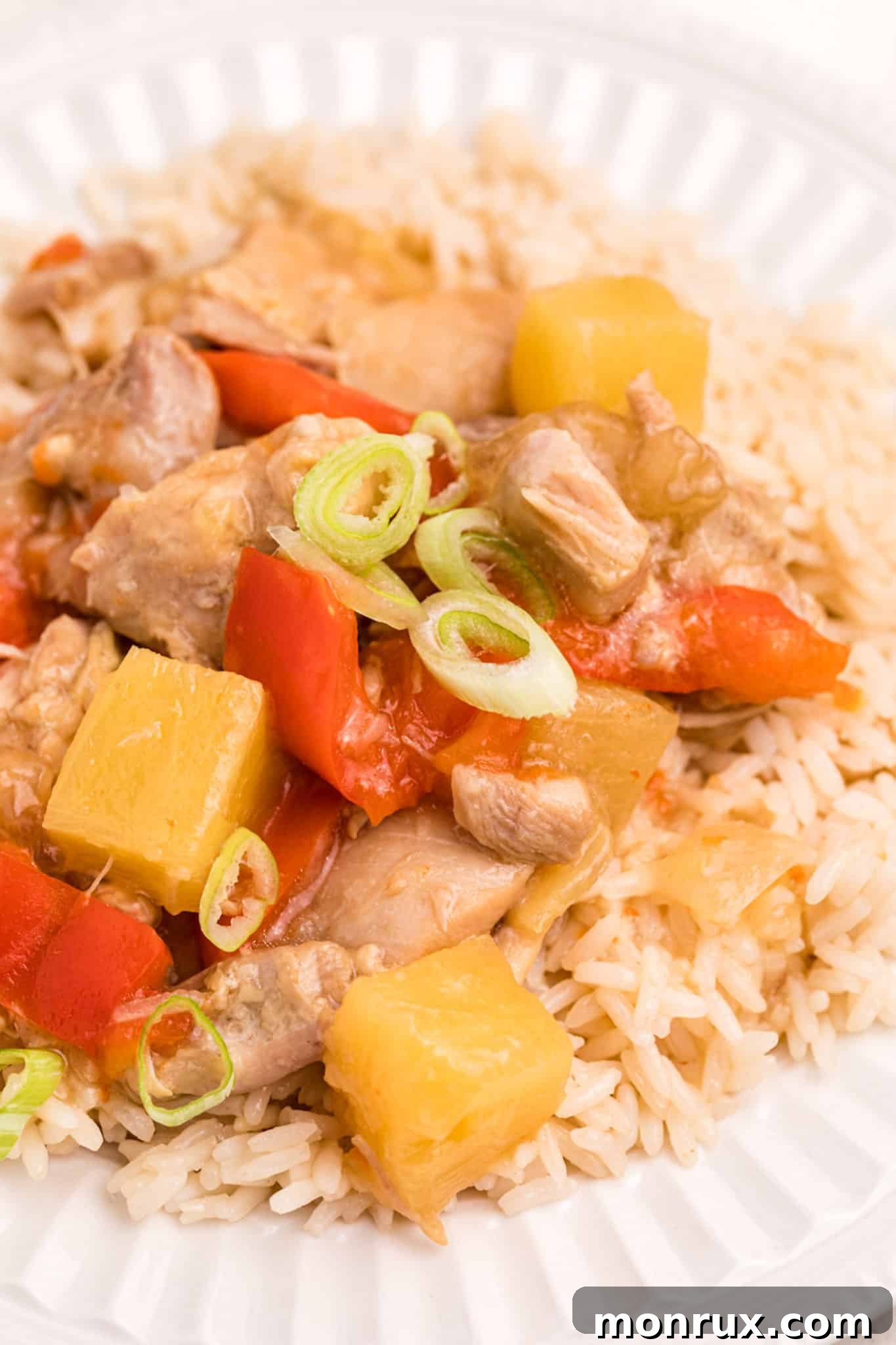 Cooked Instant Pot Pineapple Chicken with rice on a plate.