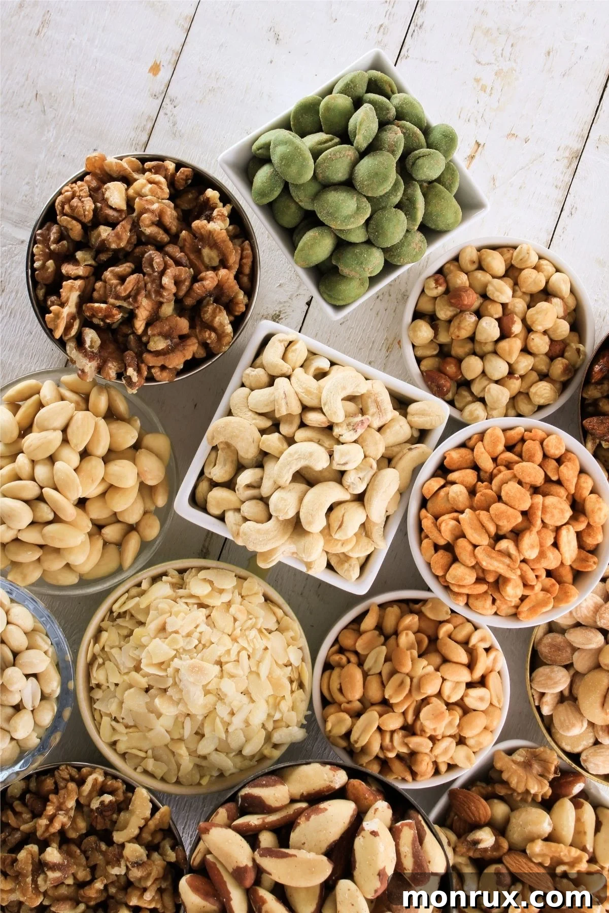 Bowls of various nuts and seeds, including almonds, walnuts, and chia seeds for clean eating