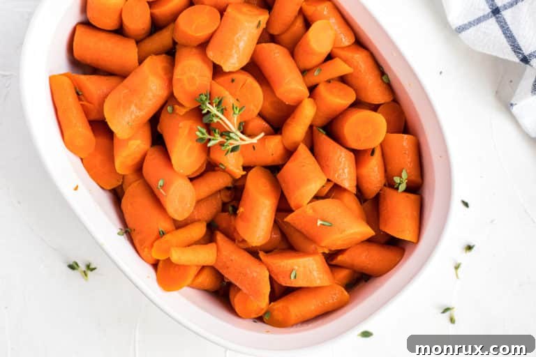 bowl with cooked carrots topped with fresh thyme