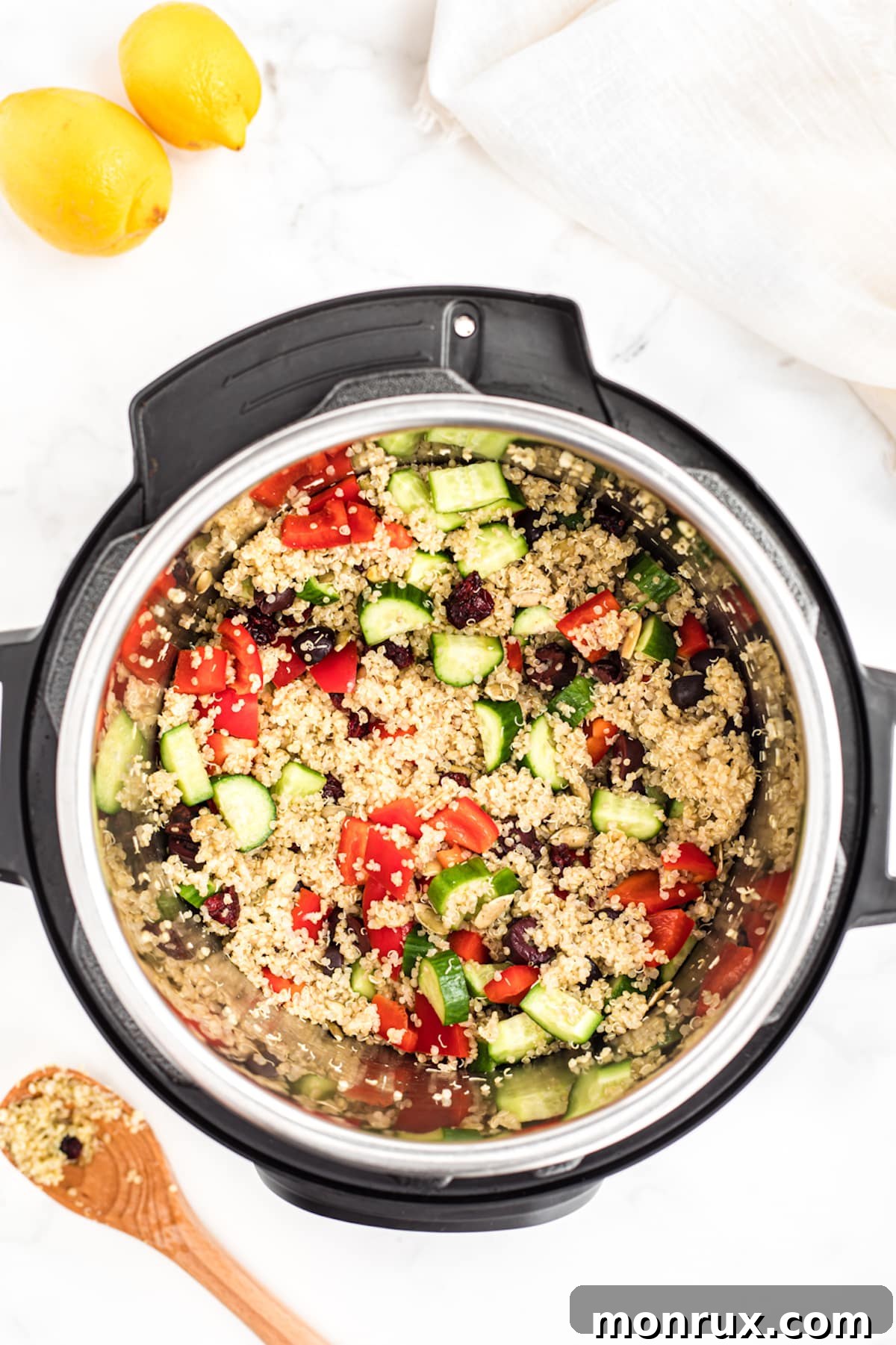 instant pot filled with cooked quinoa and chopped veggies.