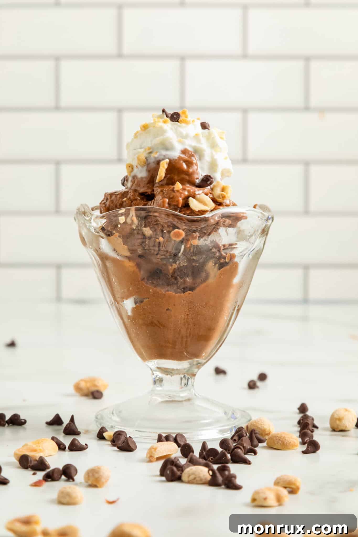 Front view of Chocolate Peanut Butter Banana Ice Cream in a sundae glass, highlighting its smooth, tempting texture.