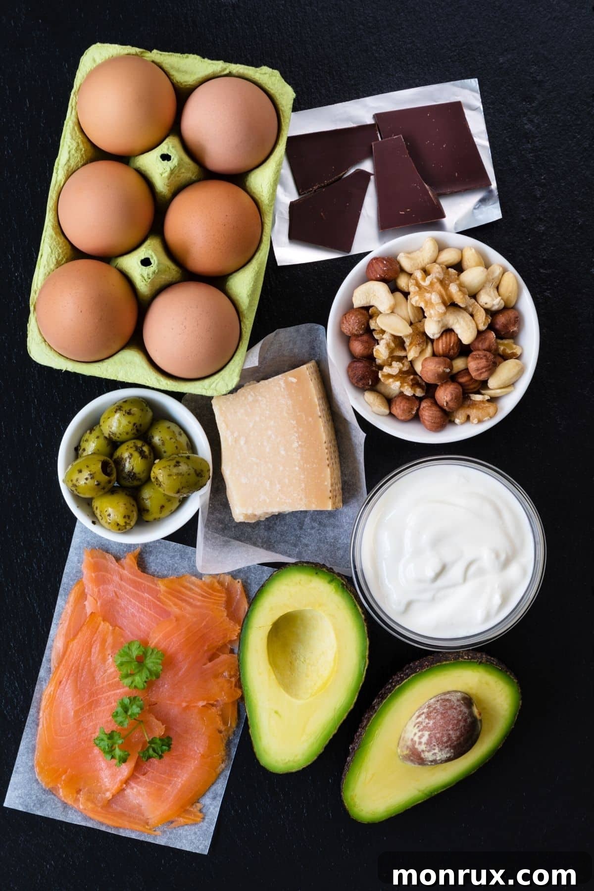 Healthy foods on a tabletop including healthy fats, fresh vegetables, fruits, and lean proteins, all beneficial for fertility.
