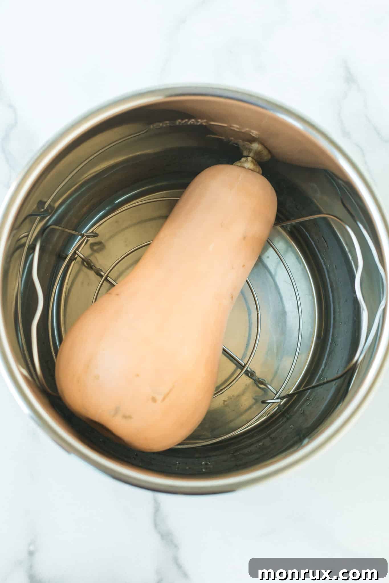 whole butternut squash inside of an instant pot pressure cooker.
