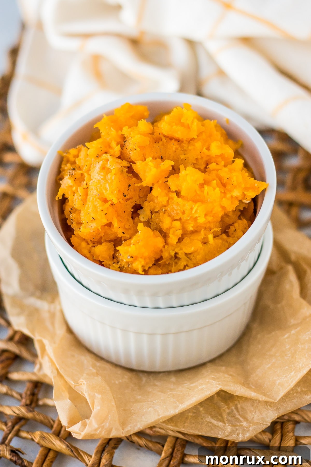 butternut squash puree served with salt and pepper in a white ramekin.