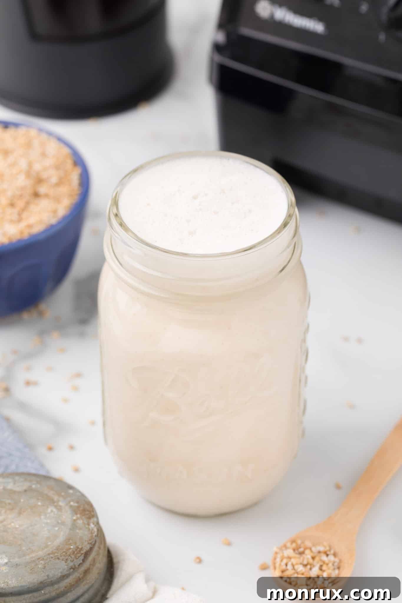 Homemade oat milk creamer in a glass jar, ready for use.