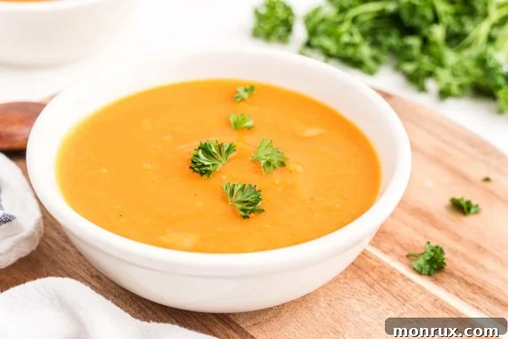 A vibrant bowl of Instant Pot Butternut Squash Soup, garnished with a sprinkle of herbs.