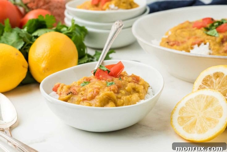 A bowl of flavorful Instant Pot Red Lentil Dal, served with rice.