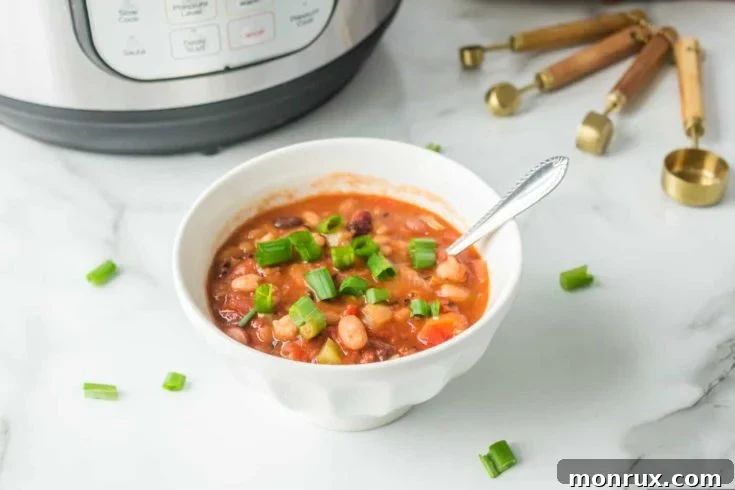 A bowl of hearty Instant Pot 15 Bean Soup, garnished with fresh cilantro.