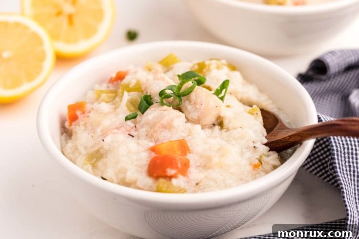 A serving of nourishing Instant Pot Chicken and Rice Soup with lemon slices and fresh dill.