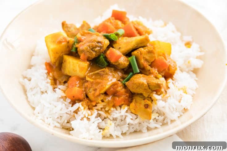 A bowl of rich Instant Pot Indian Chicken Curry, garnished with fresh herbs.
