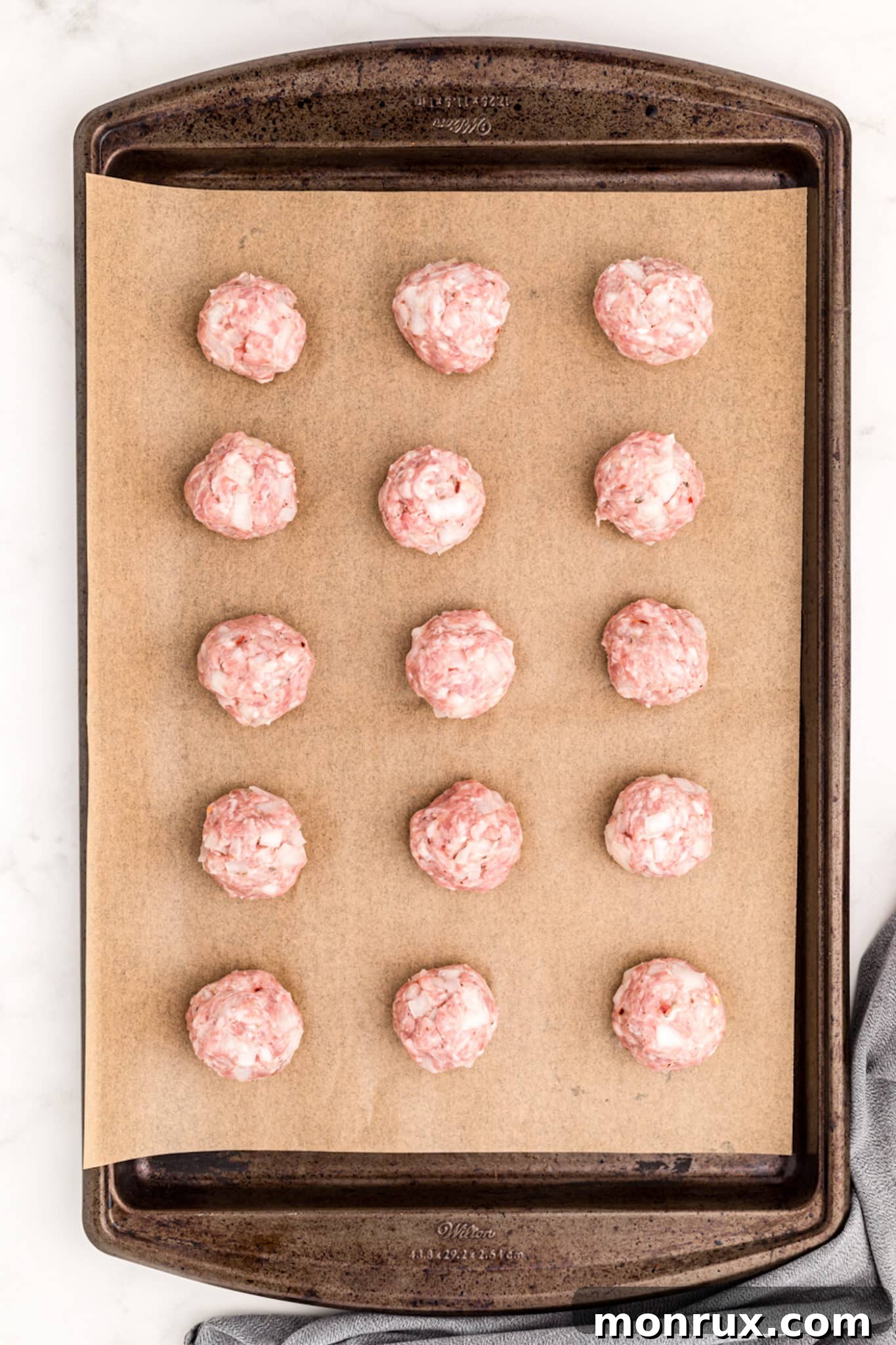 formed meatballs on a parchment-lined baking pan