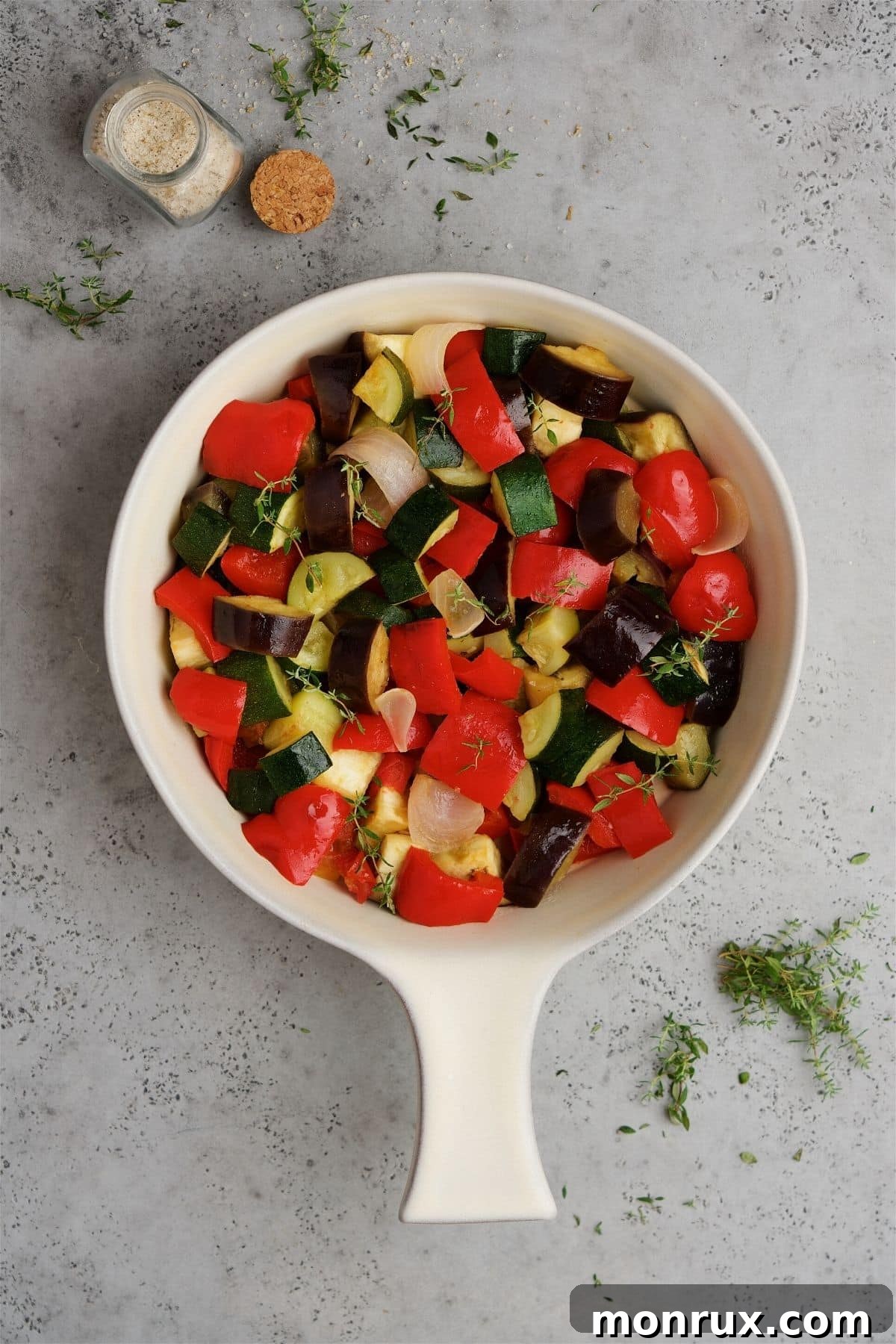 ceramic pan with fresh, colorful vegetables ready for cooking.