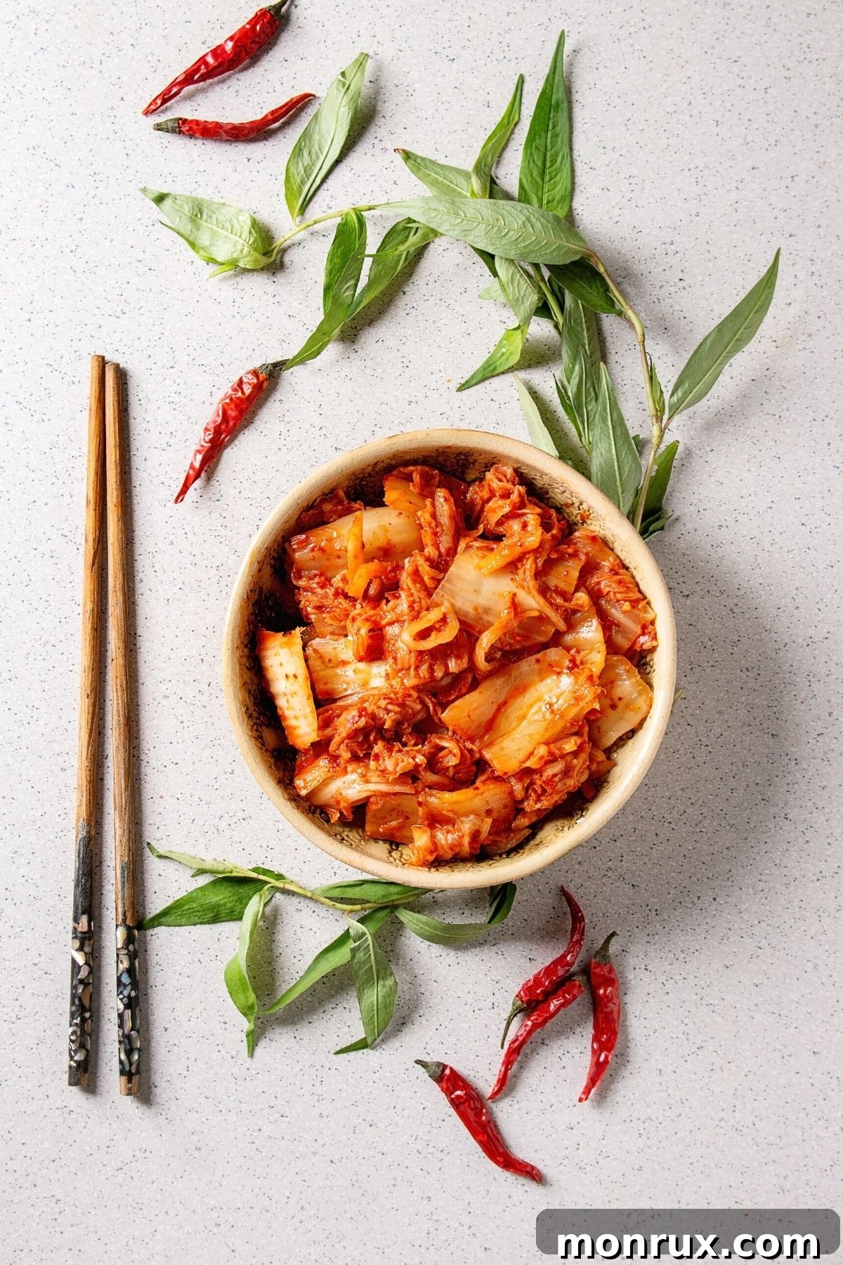 A vibrant bowl of spicy Korean kimchi, showcasing its rich red color and tantalizing texture.