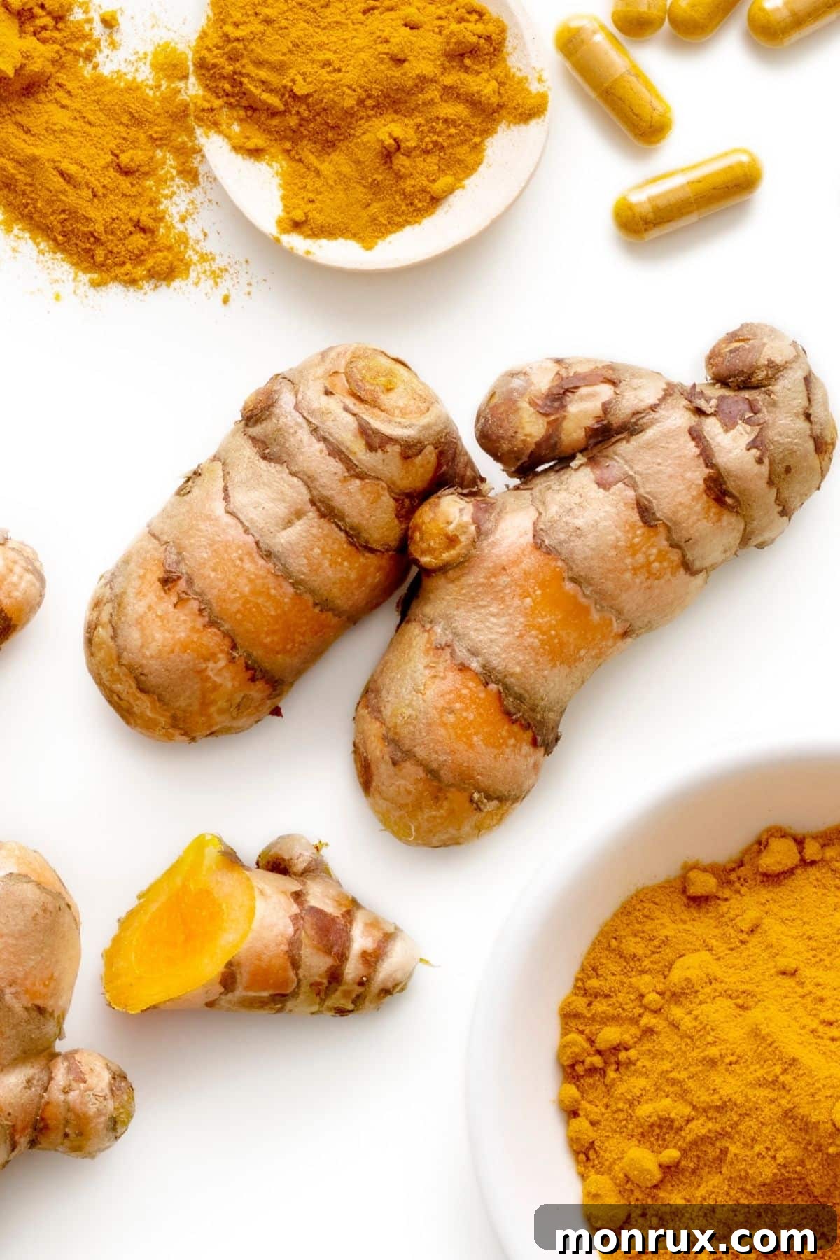 Turmeric root on a table with ground turmeric in a bowl, representing natural antihistamine remedies.