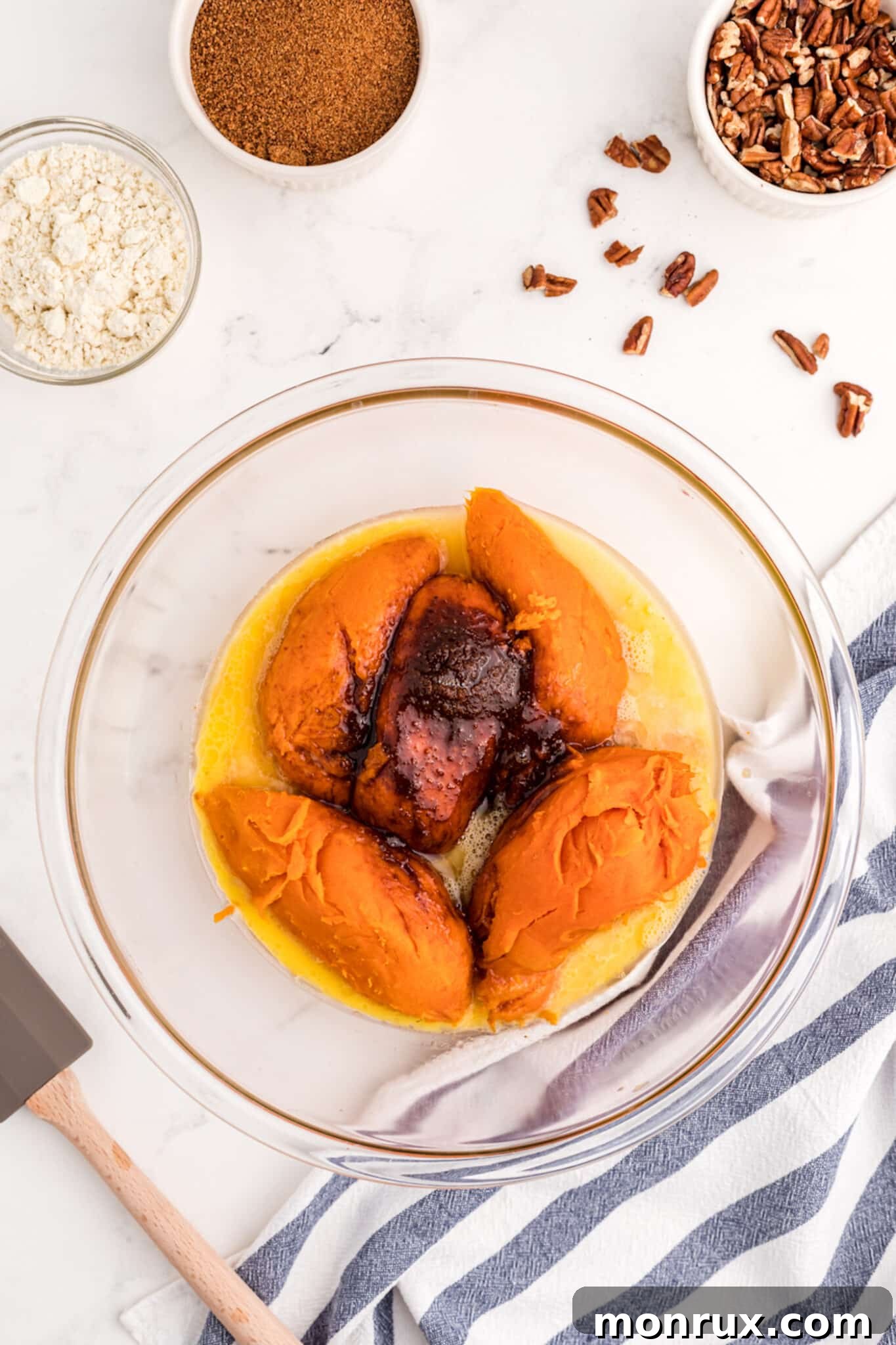 A bowl filled with freshly cooked and peeled sweet potatoes, ready to be mashed for the casserole filling.