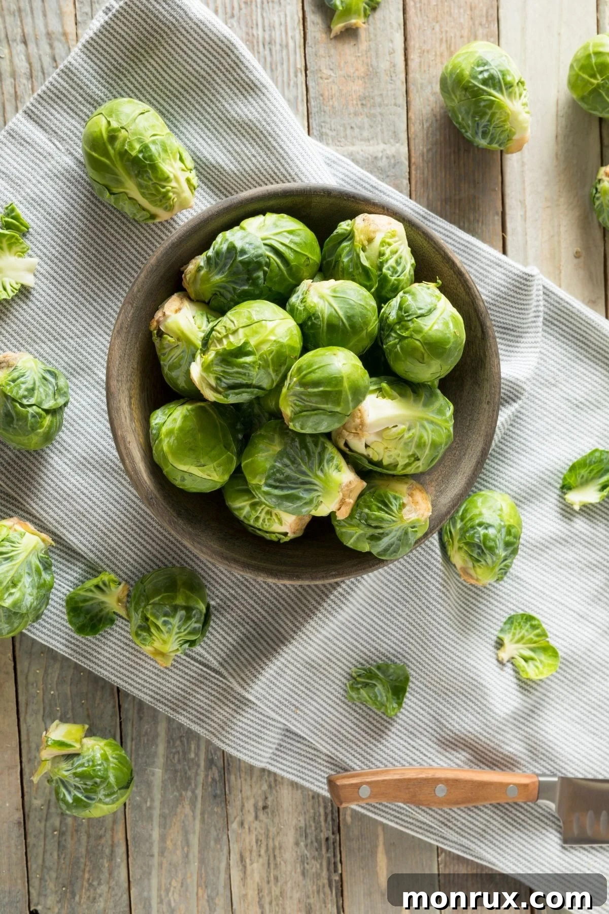 A rustic bowl overflowing with fresh Brussels sprouts, ready for roasting or cooking.