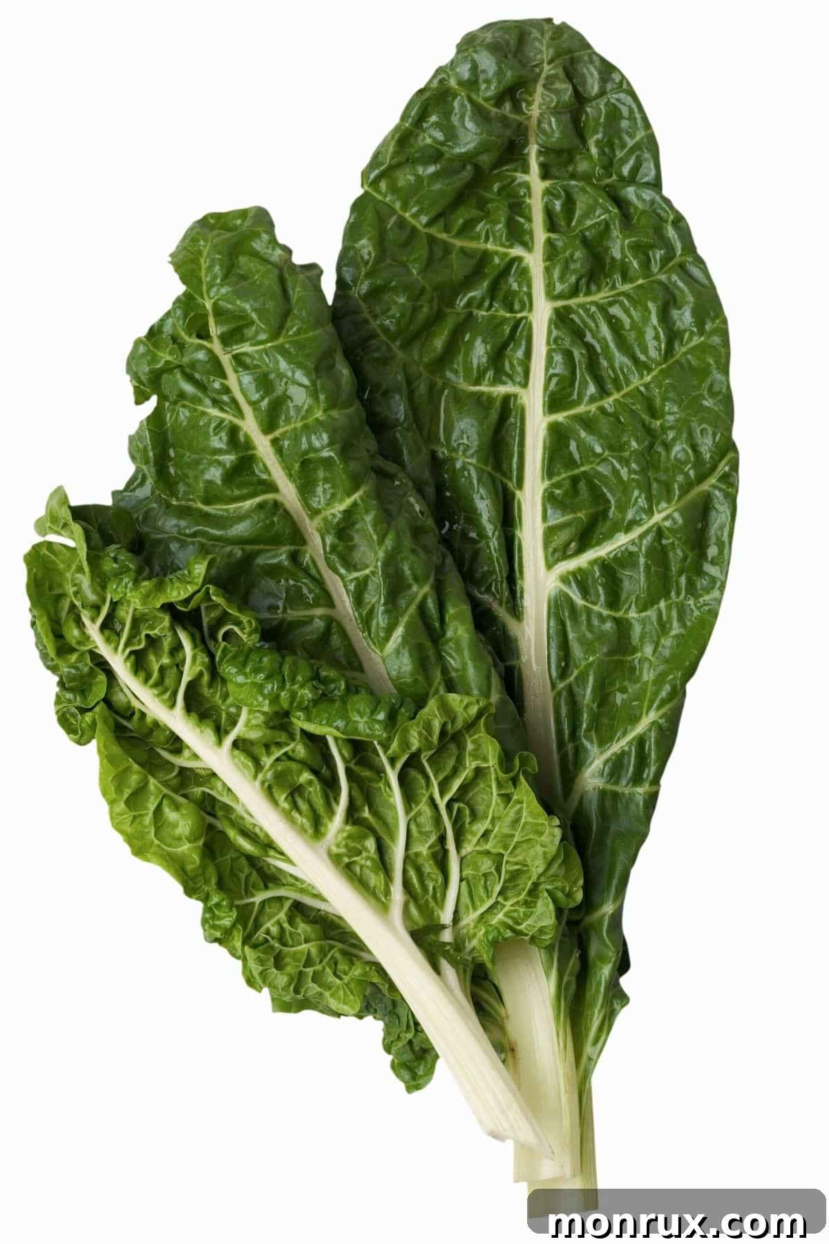 A vibrant bunch of fresh Swiss chard with colorful stems laid on a wooden table.