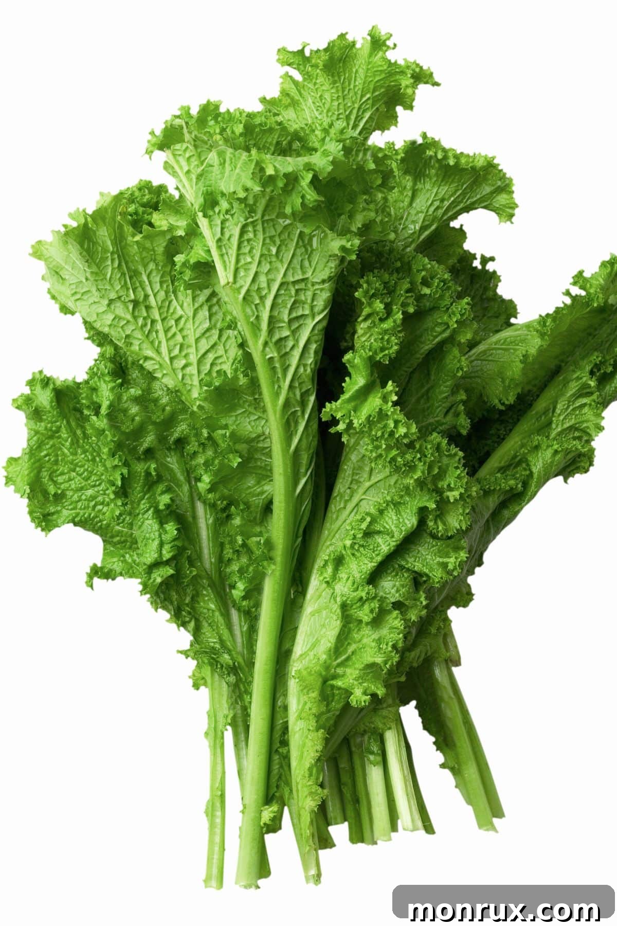 A heap of fresh, ruffled mustard greens on a wooden table, highlighting their vibrant green color.