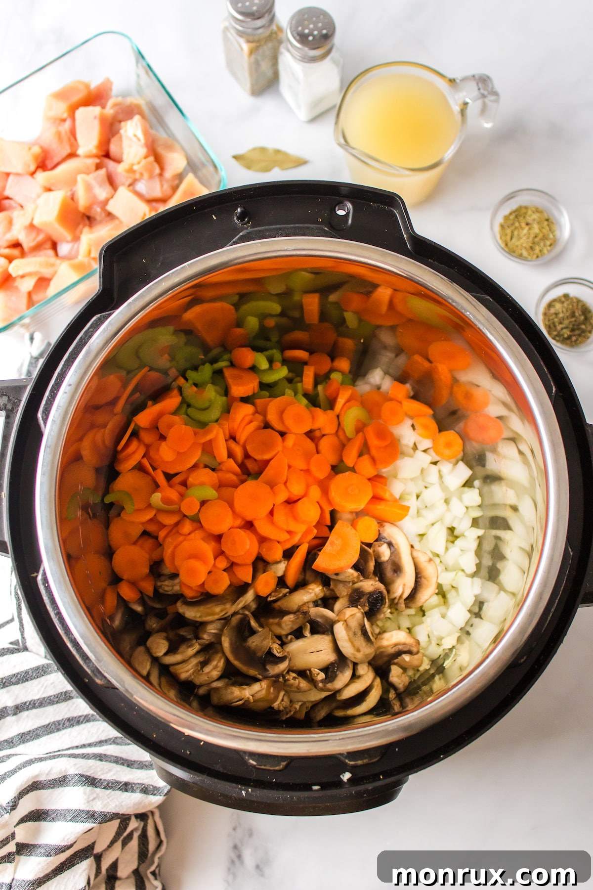 Diced vegetables and olive oil in a pot, ready for sautéing.