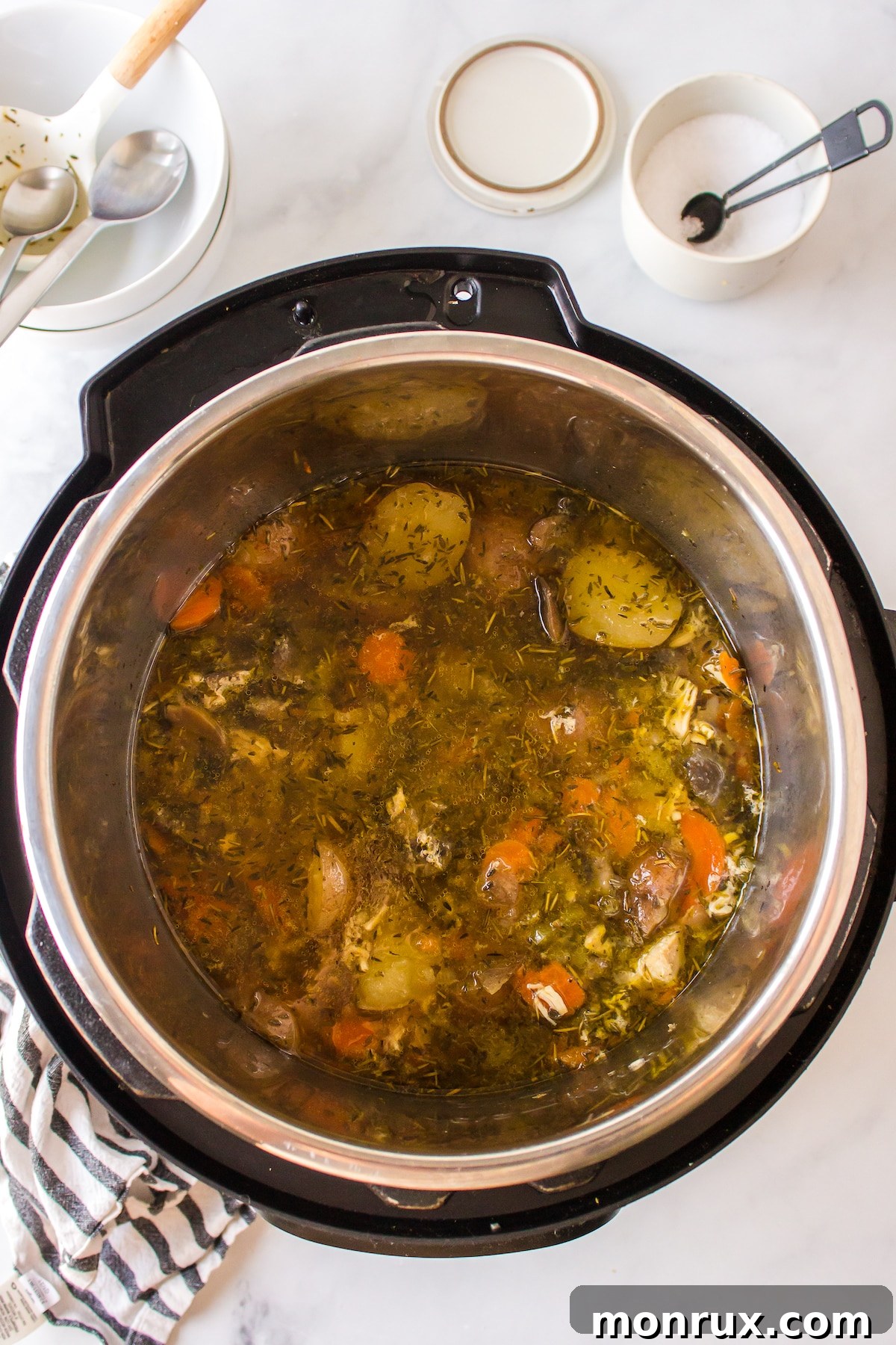 Finished chicken and potato soup simmering in a pot.