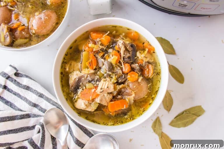 chicken soup with potatoes served in white bowls.