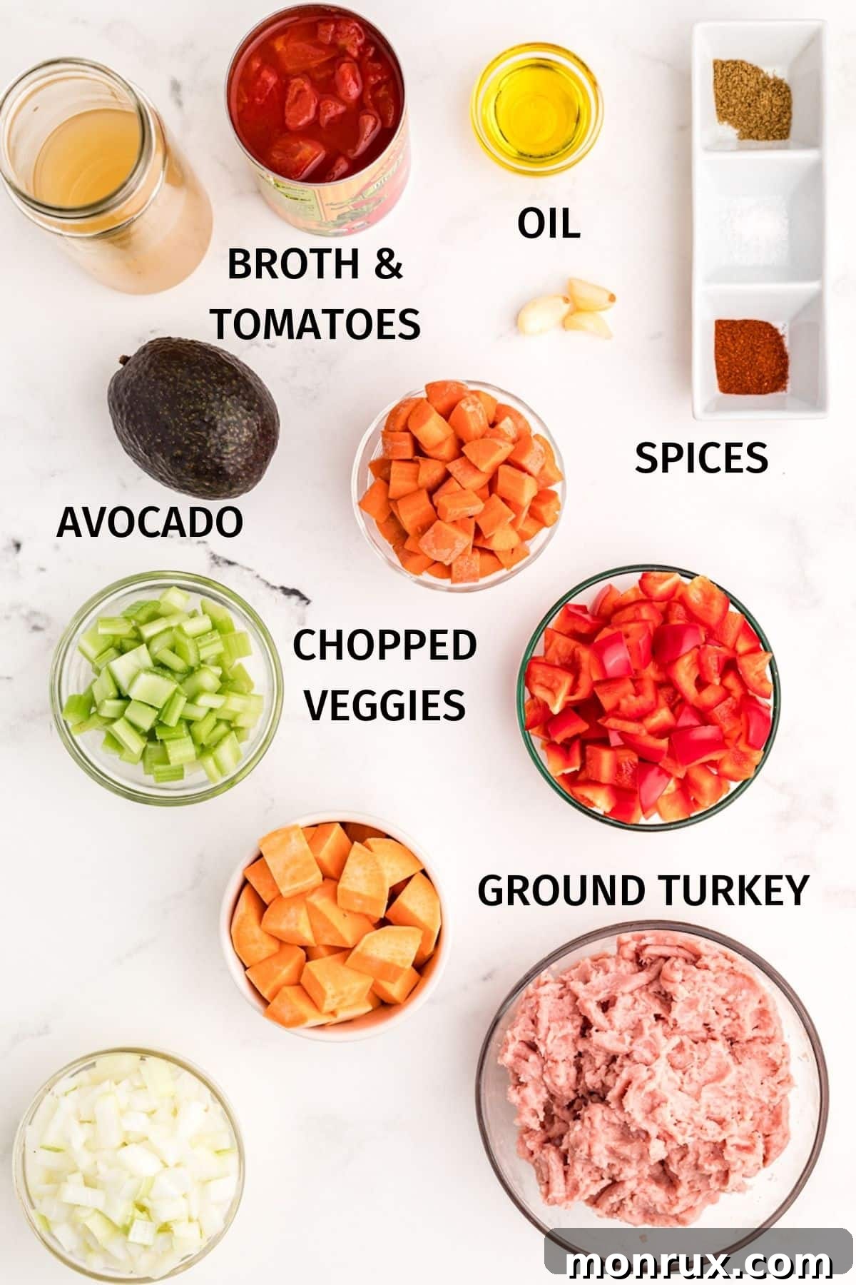 An array of fresh, labeled ingredients laid out, featuring ground turkey, vibrant vegetables like sweet potatoes and bell peppers, and essential spices, ready for making Instant Pot Turkey Chili.