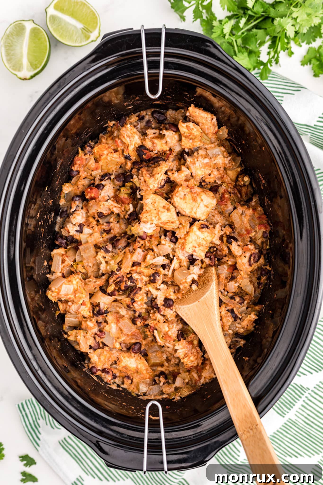 A crockpot showcasing the perfectly cooked chicken and rice, ready to be served.