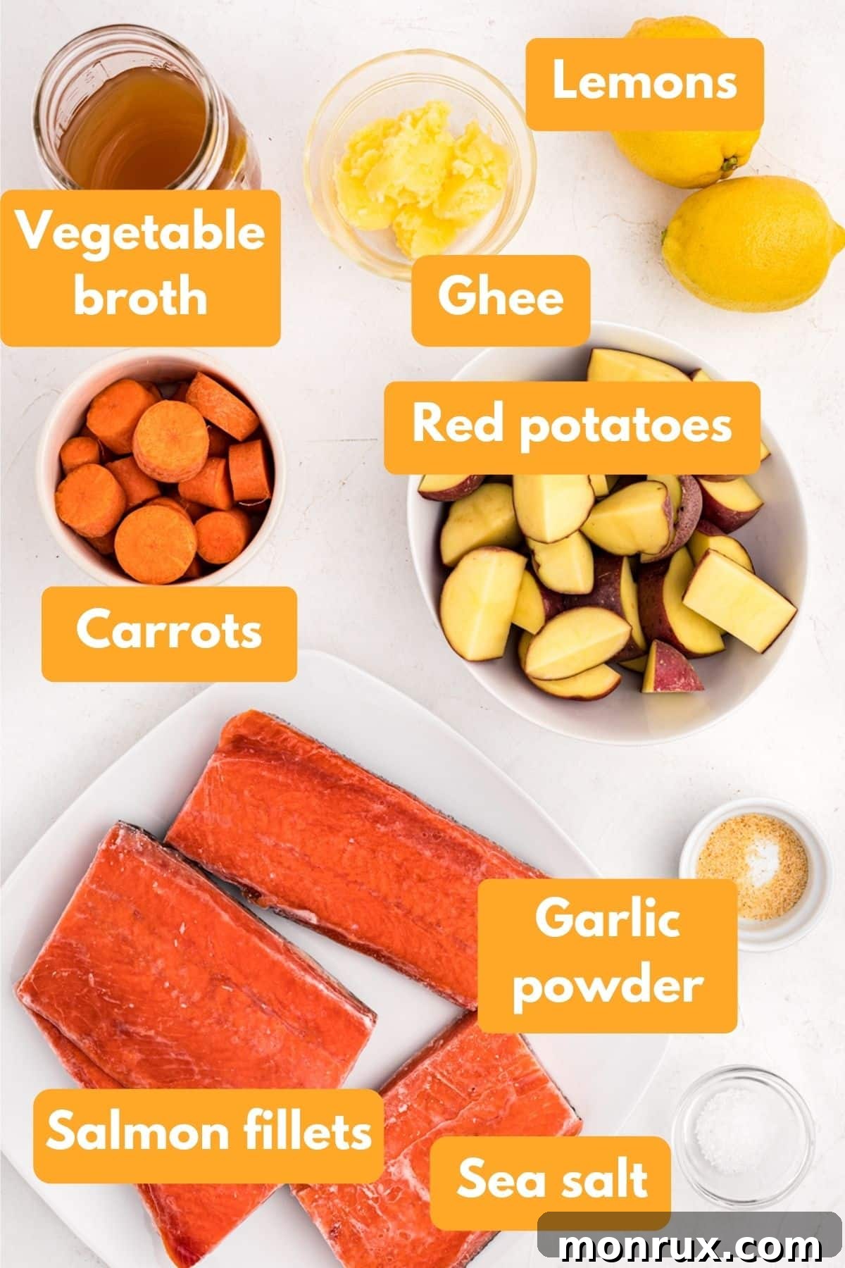 ingredients for salmon and potatoes, including fillets, potatoes, broth, and lemon