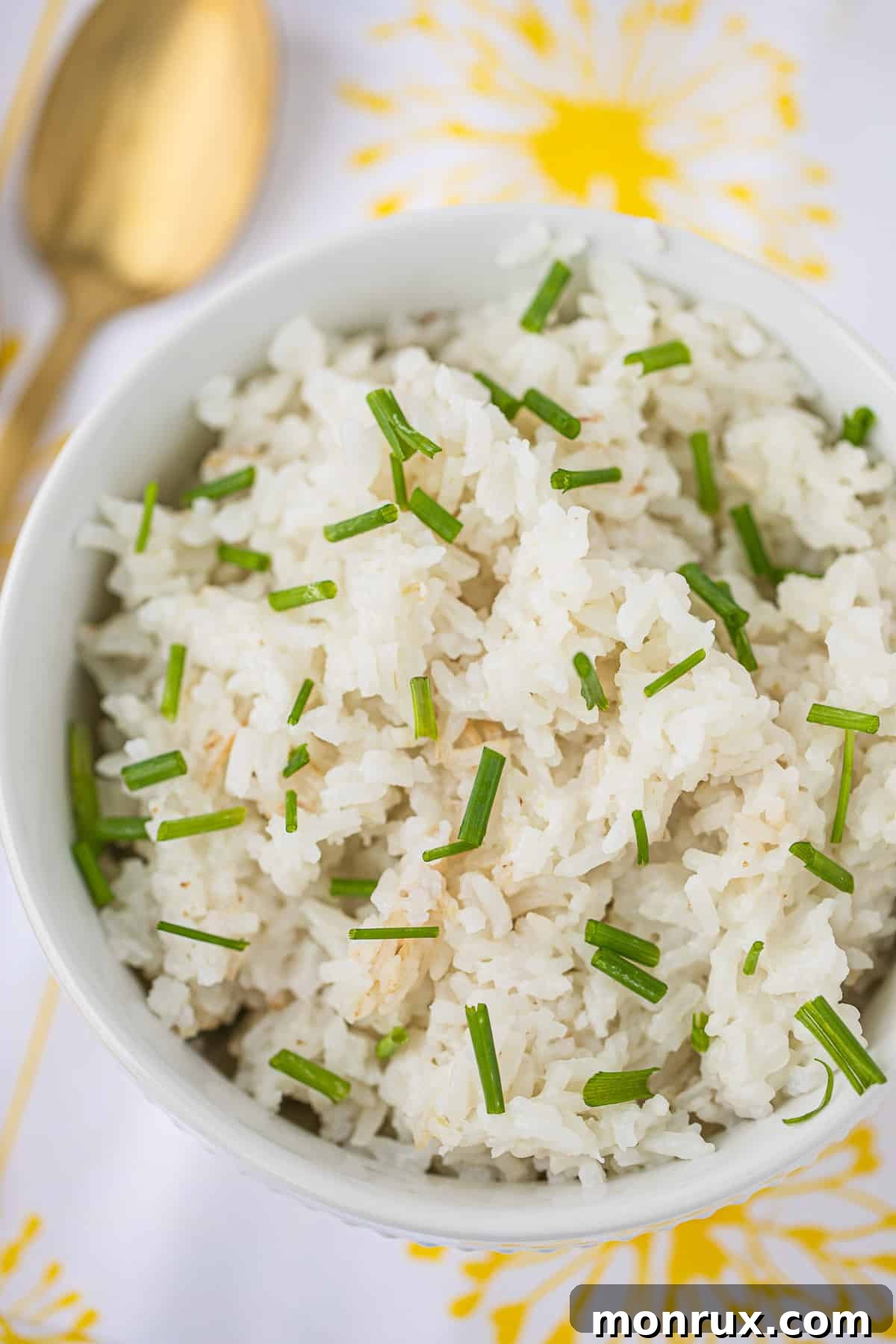 A beautifully presented bowl of Instant Pot Coconut Rice, garnished with fresh chives, ready to be served as a delightful side dish.