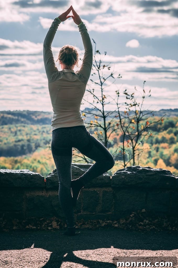 A woman gracefully performing a yoga pose outdoors, symbolizing physical vitality and mental serenity.