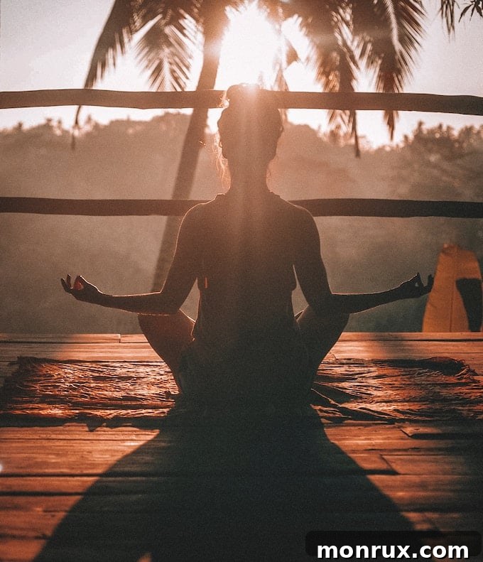 A woman meditating peacefully outdoors at sunset, surrounded by nature, symbolizing inner joy and harmony.