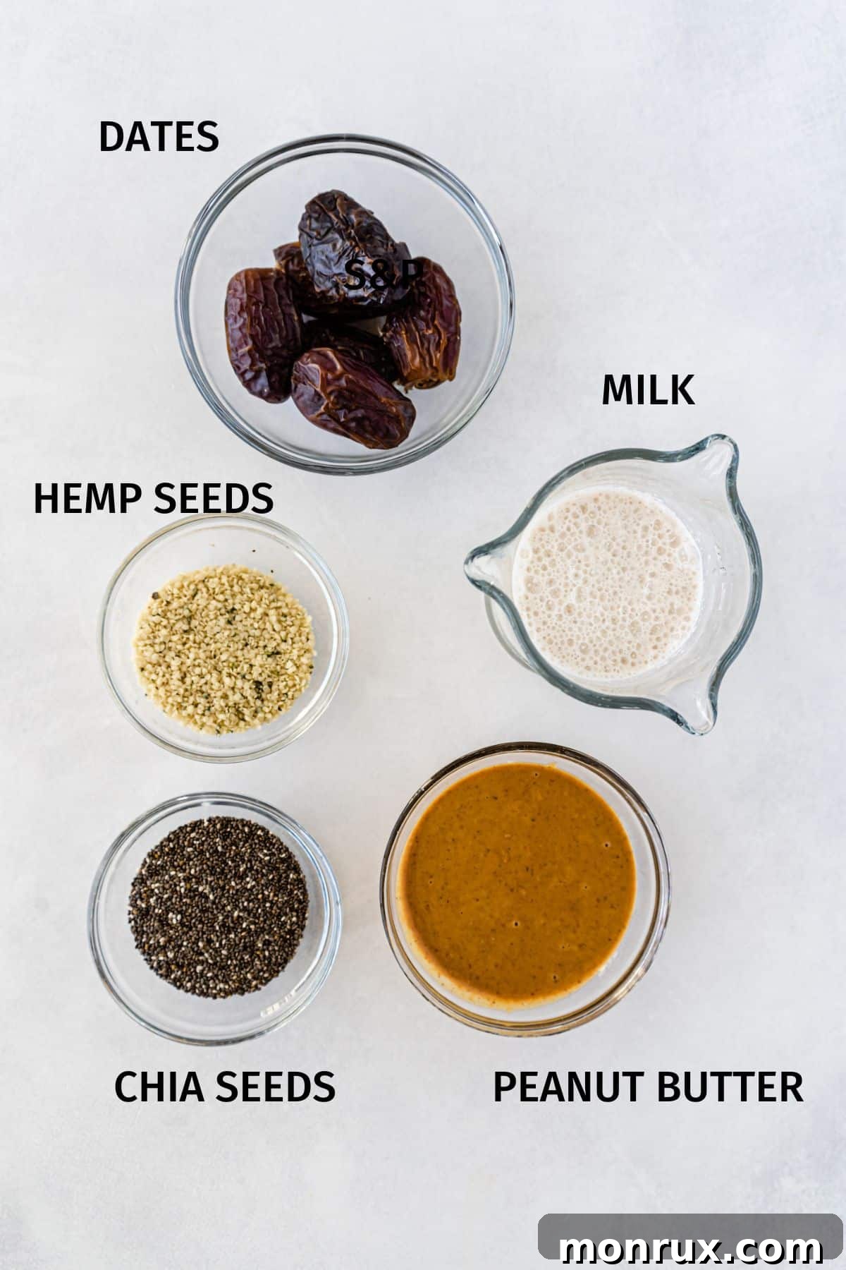 Individual bowls containing key ingredients to make peanut butter chia seed pudding, including peanut butter, chia seeds, sweetener, and milk.