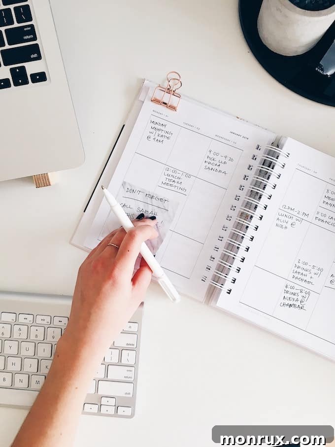 An open daily planner with various entries and a pen, symbolizing organized planning and setting daily intentions.