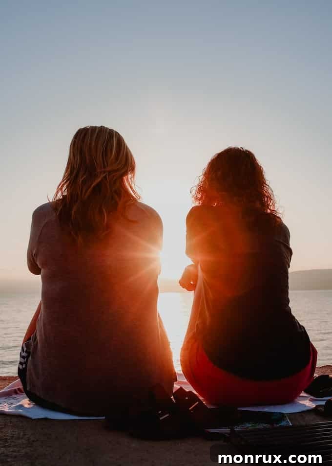 Two friends sharing a peaceful moment, sitting together on the edge of a serene lake, symbolizing companionship and emotional support.