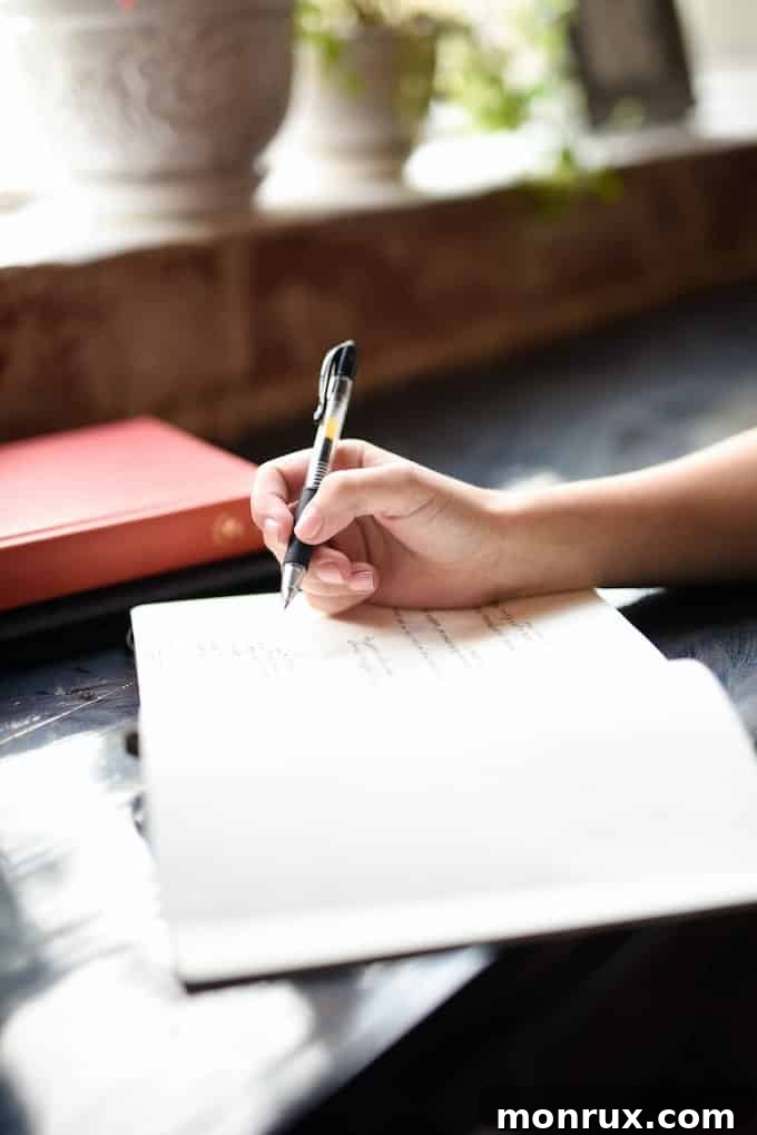 An overhead view of a journal with handwritten notes and a pen, symbolizing the practice of journaling for reflection, gratitude, and goal setting.