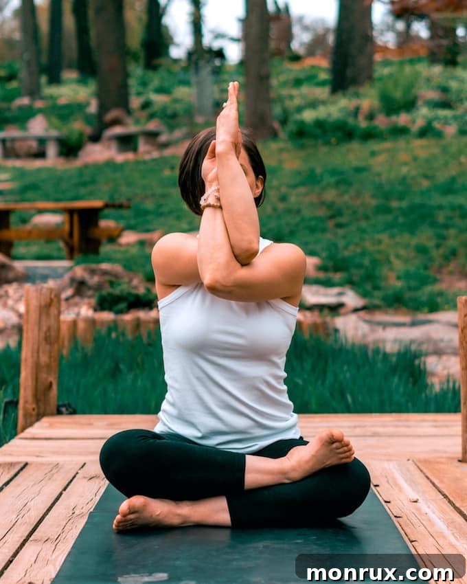 woman doing yoga outdoors in a serene setting.