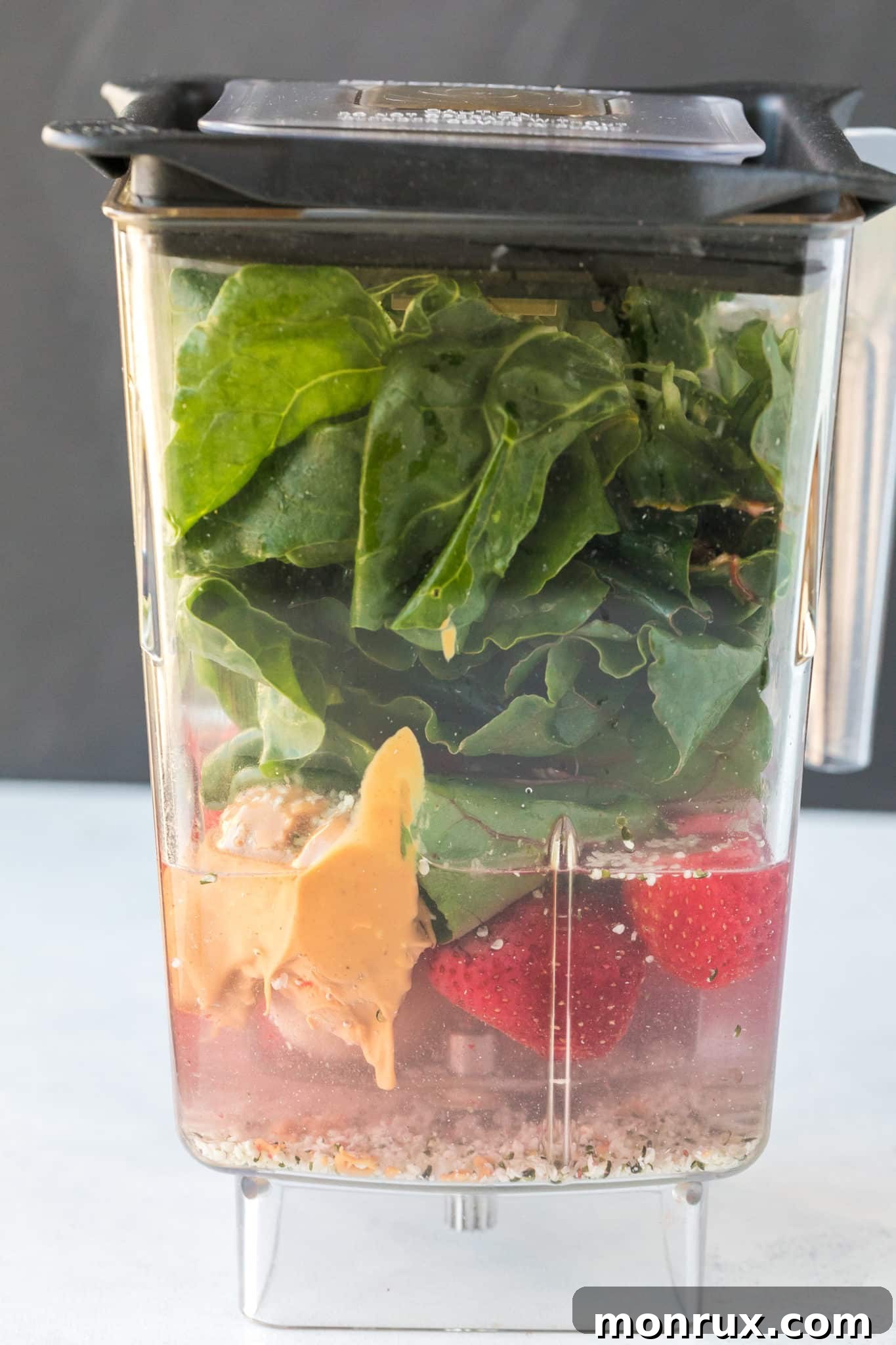 All ingredients for the Swiss chard smoothie placed in a high-speed blender, ready to be processed.