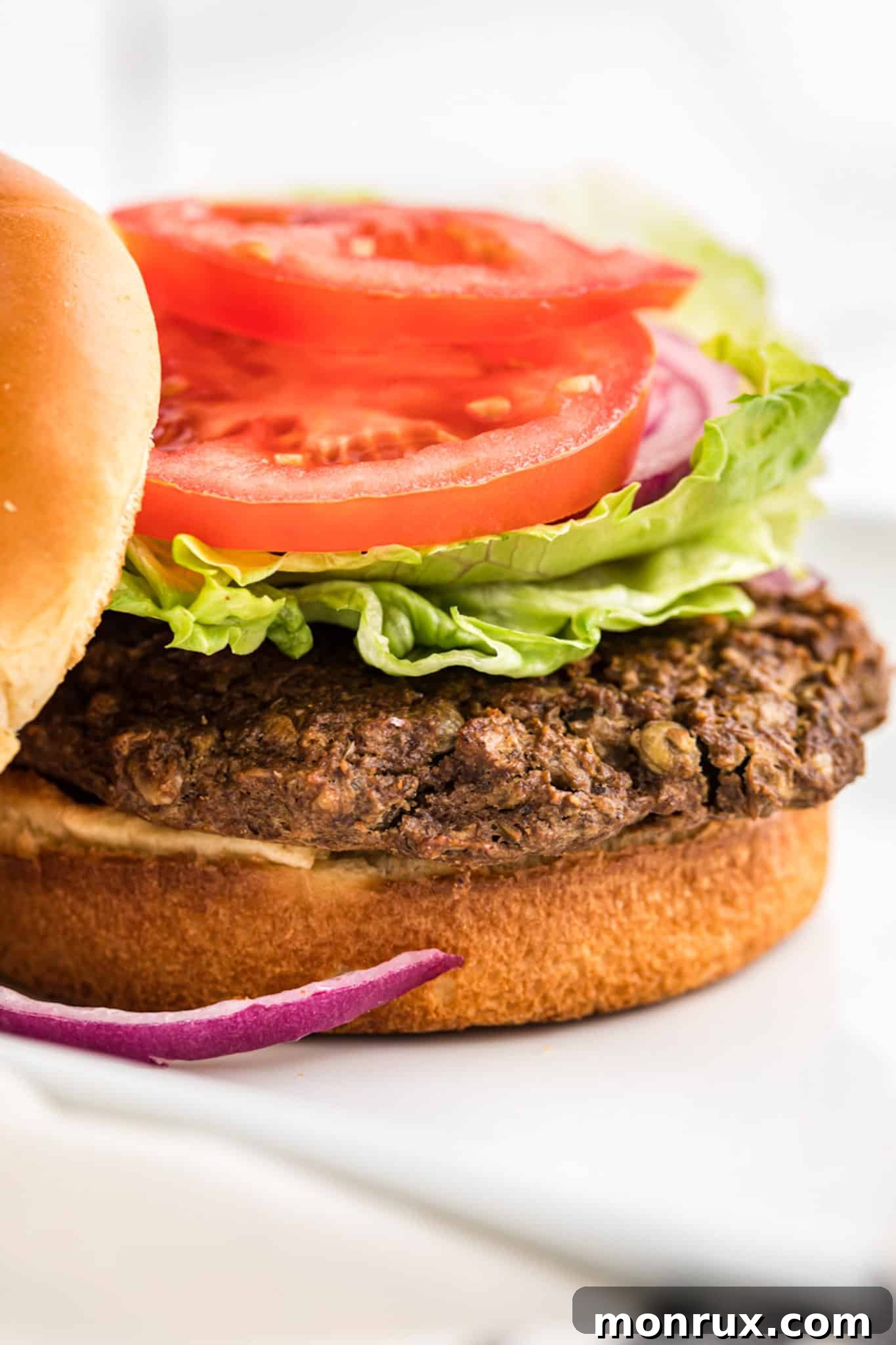 Close-up shot of a perfectly baked lentil burger, showcasing its texture and golden crust.